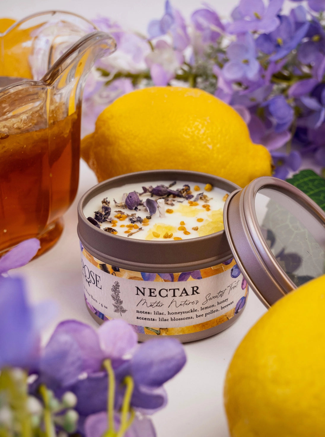 Jar of candle with lemons and honey in the background