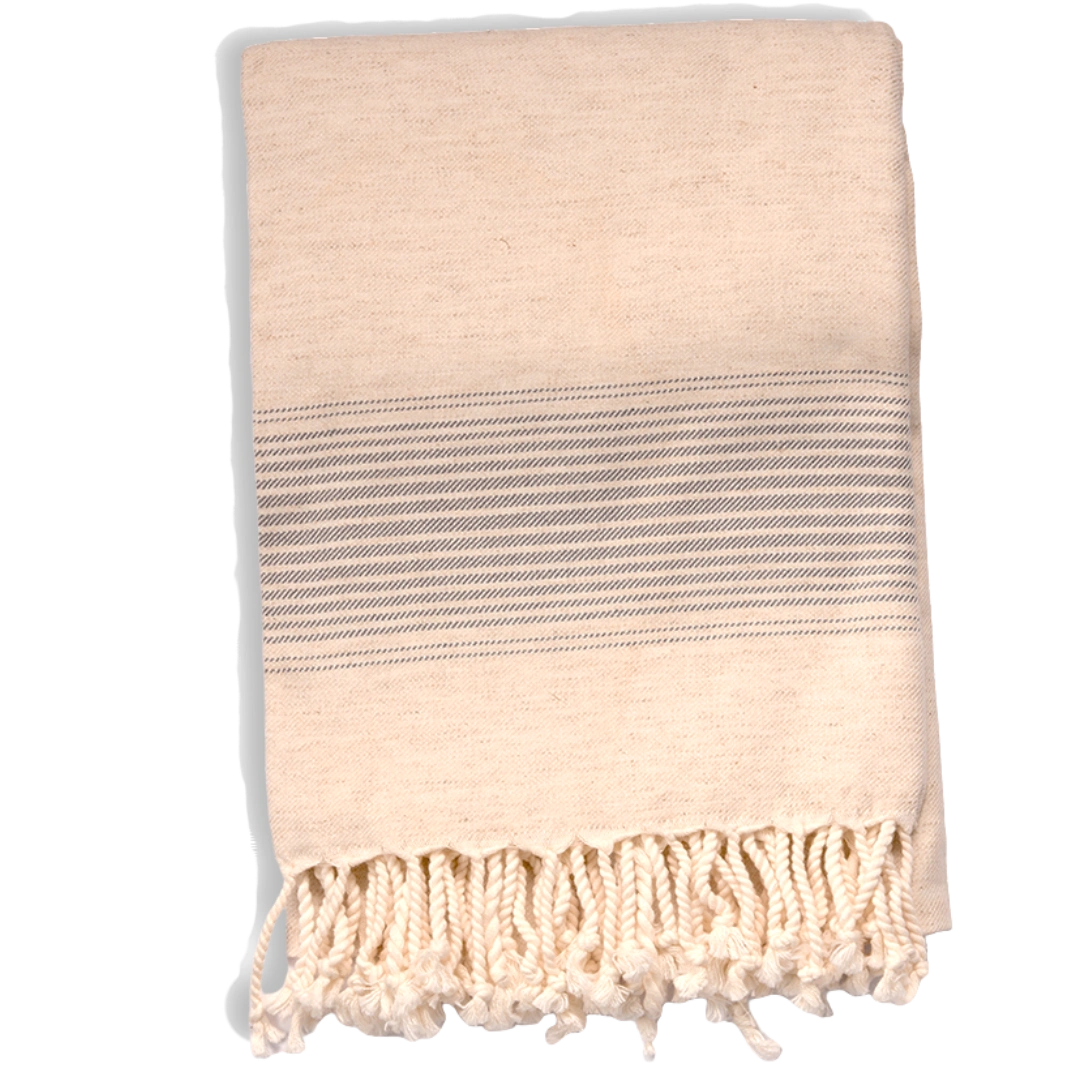Beige towel with a striped pattern and fringes on a white background