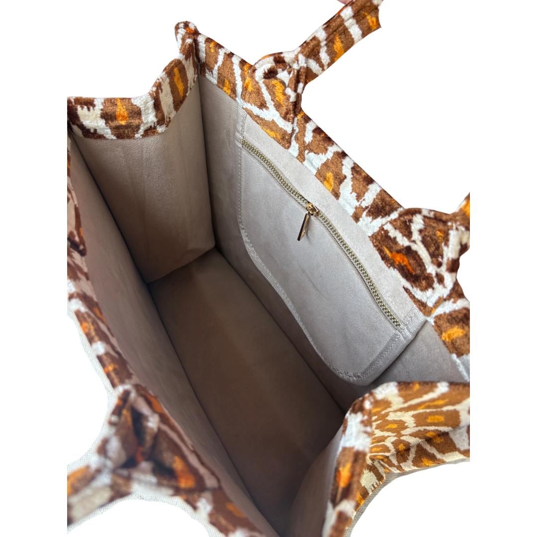 Close-up of a handbag with a patterned handle and interior.