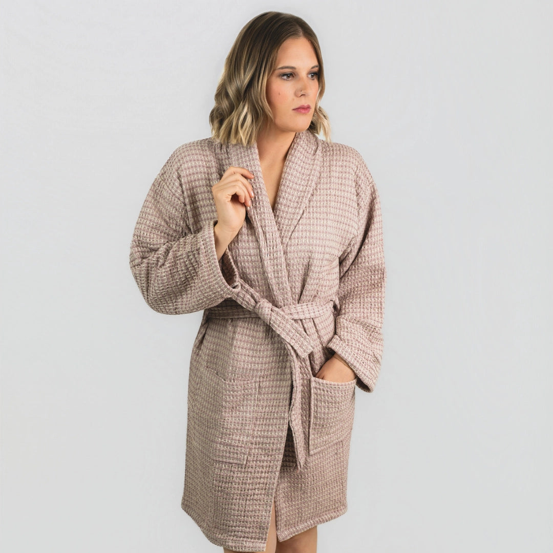 Woman wearing the Aegean Rose Petal waffle weave peshtemal bathrobe, front view