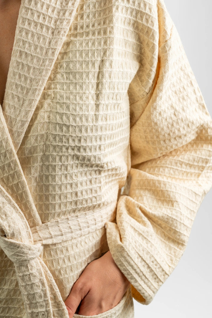 Close-up of the honeycomb waffle weave on the Aegean Sand Beige peshtemal bathrobe