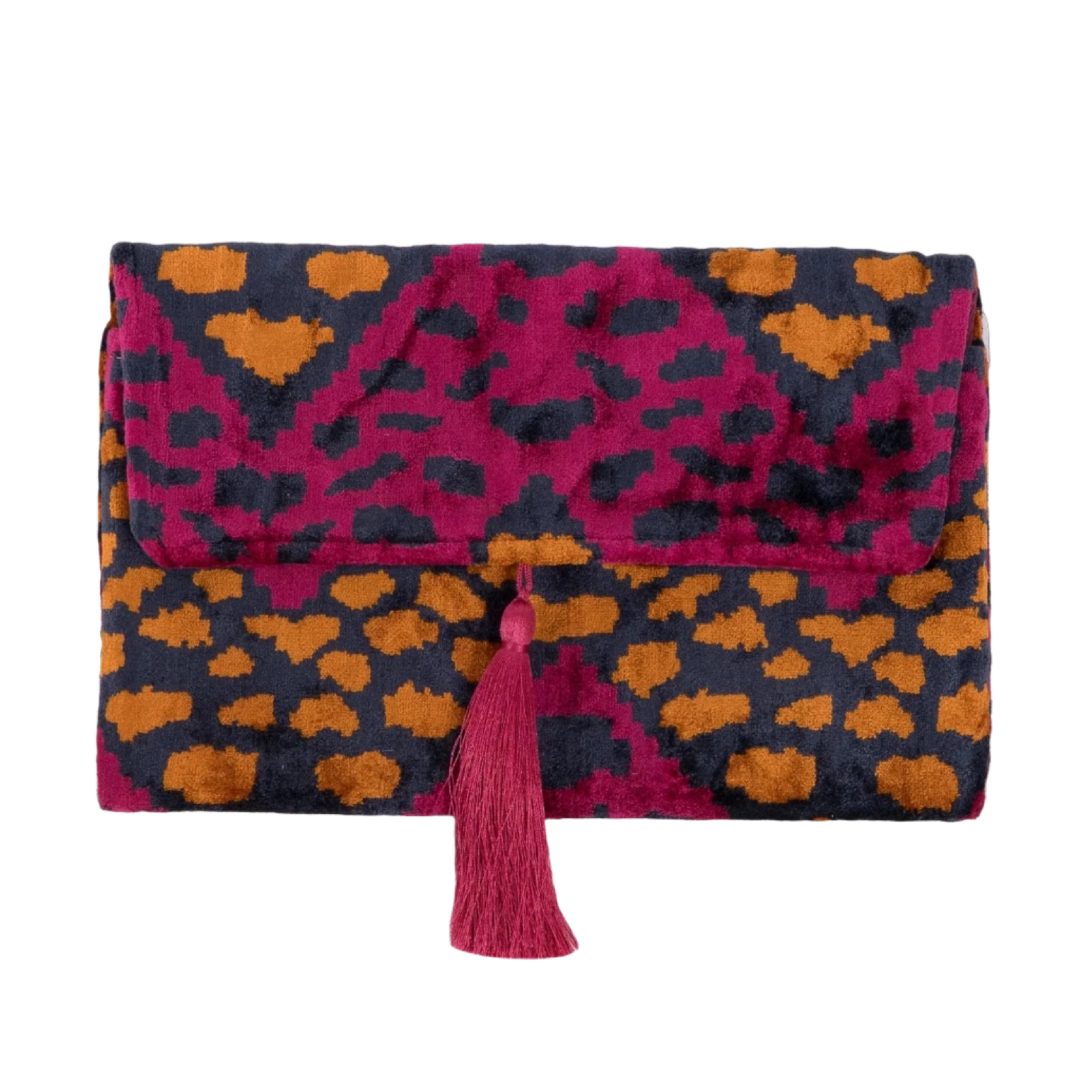 Amber leopard spots on a berry and navy silk velvet clutch with a fuchsia tassel