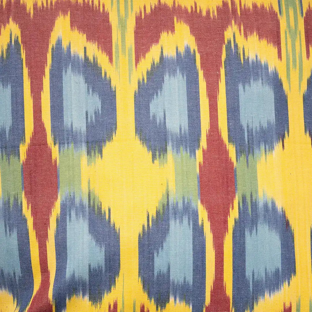 Close-up of the amber ikat weave and its slate blue teardrop motifs