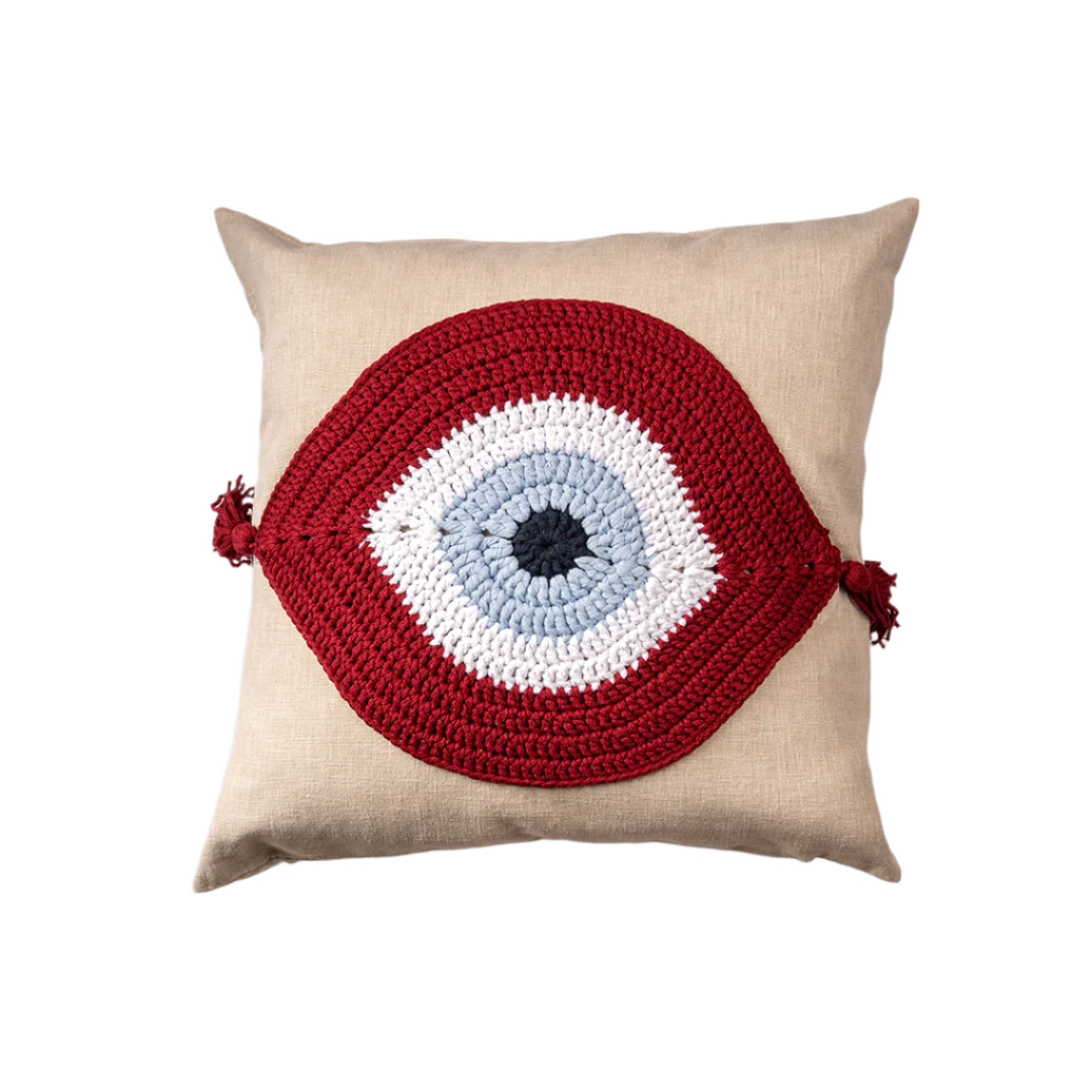 Natural linen cushion with a burgundy and ivory crocheted evil eye and corner tassels