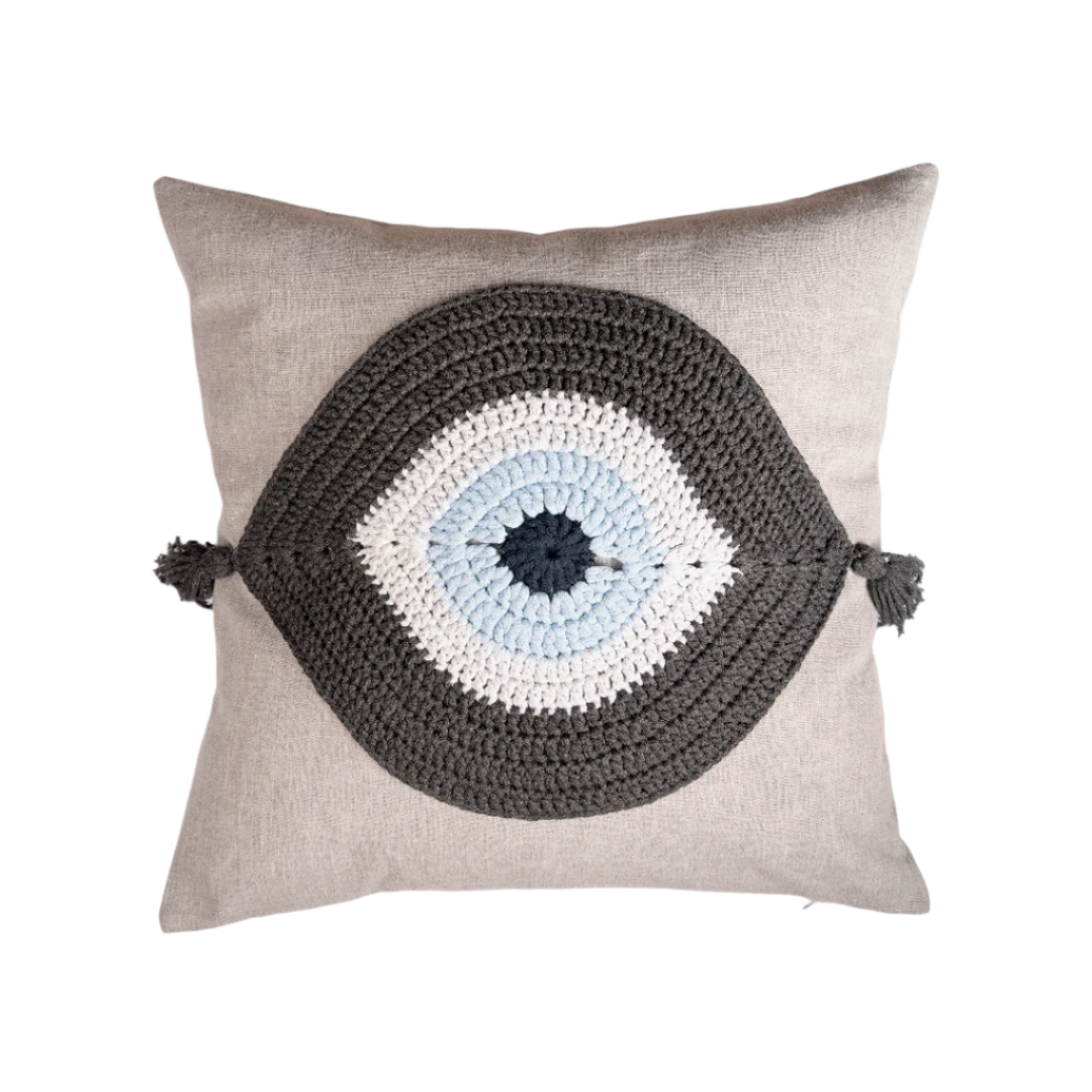 Natural linen cushion with a charcoal and ivory crocheted evil eye and corner tassels