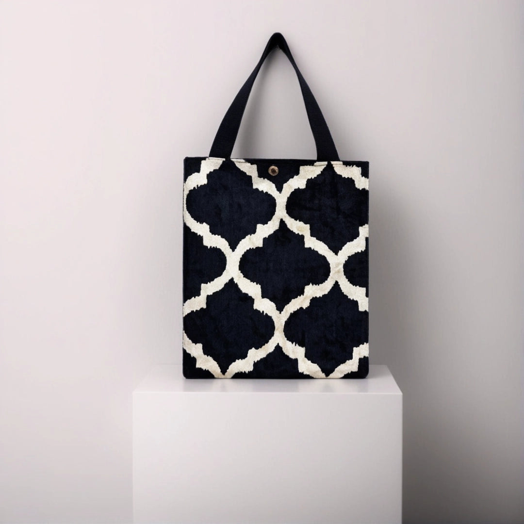 Midnight Moroccan trellis silk velvet shoulder bag displayed on a white pedestal