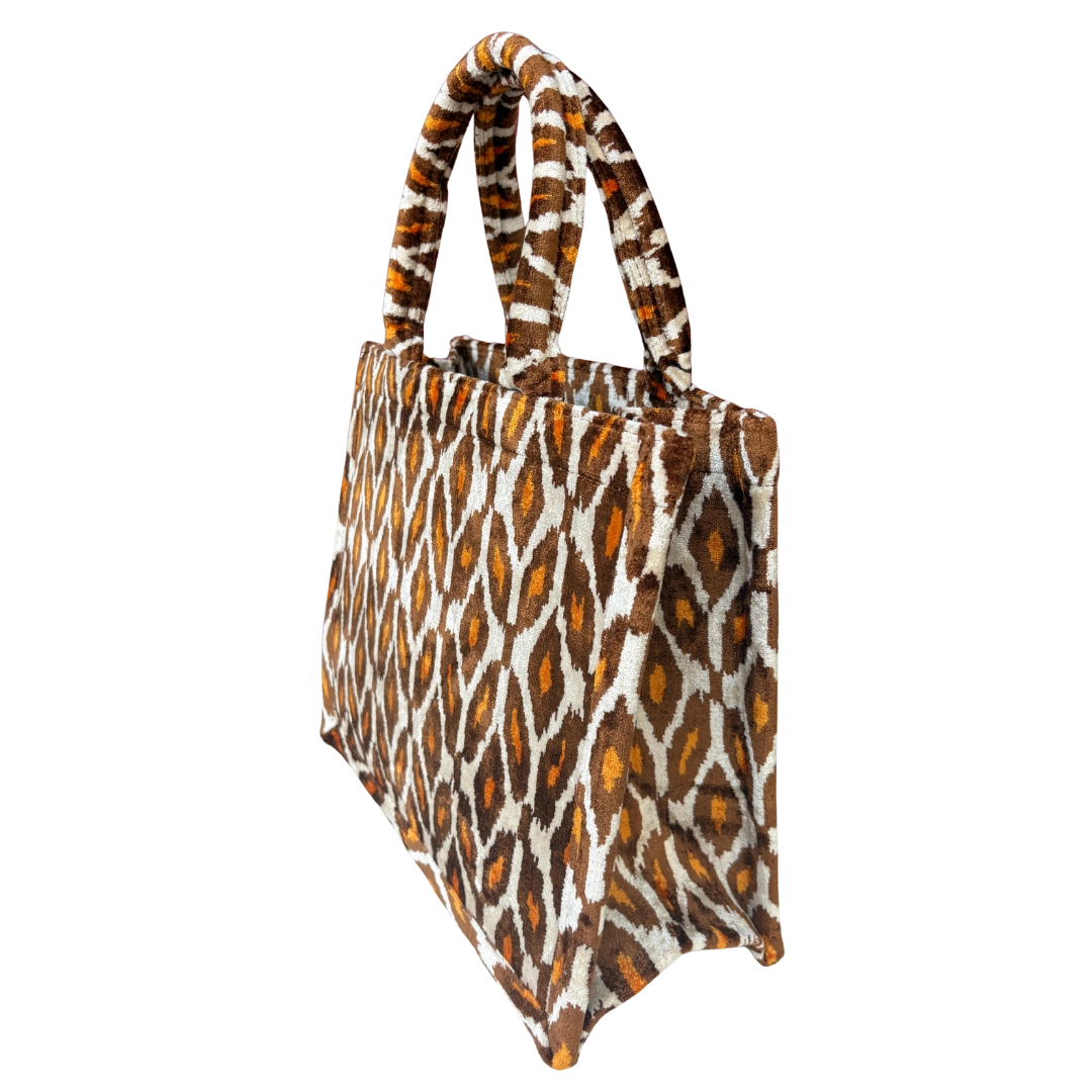 Side view of the Amber Ikat Diamond silk velvet tote showing its boxy base and gusset