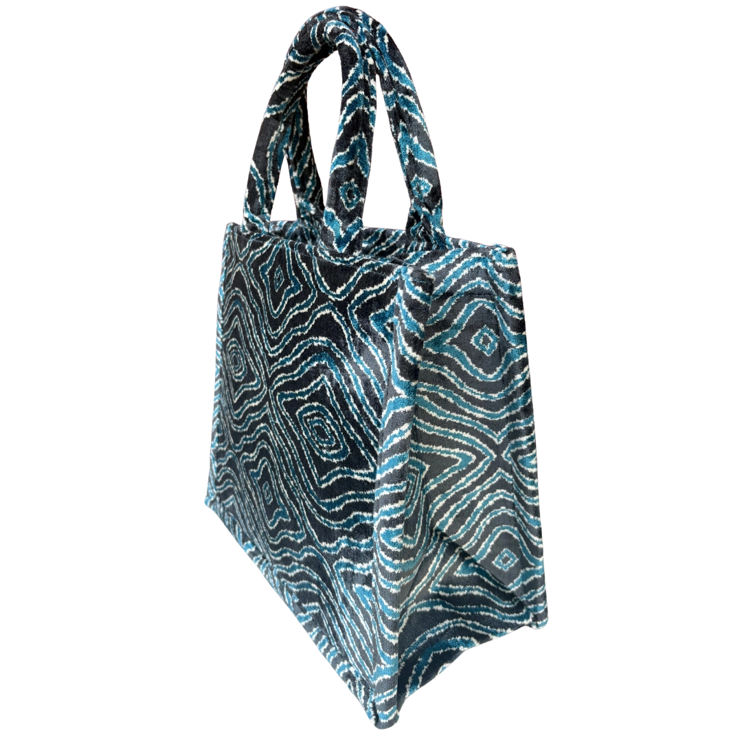 Side view of the Charcoal Wave silk velvet tote showing its boxy base and gusset