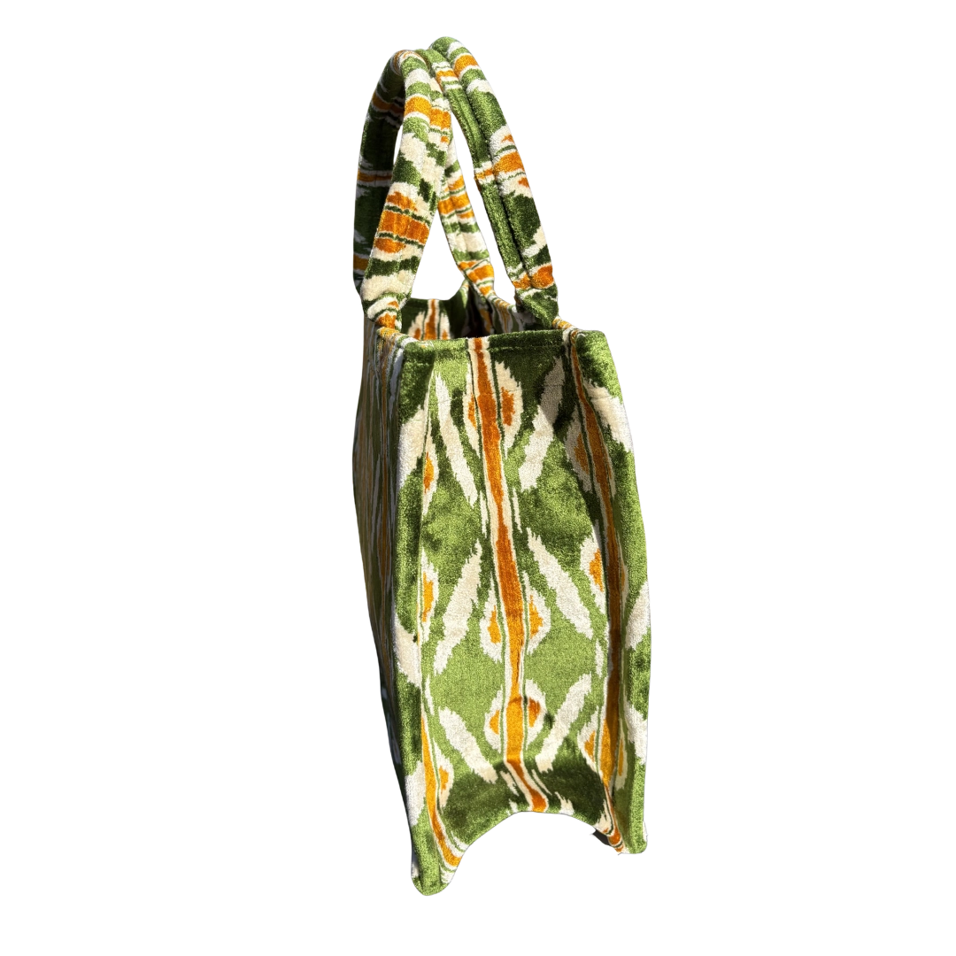 Side view of the Meadow Ikat Chevron silk velvet tote showing its boxy base and gusset