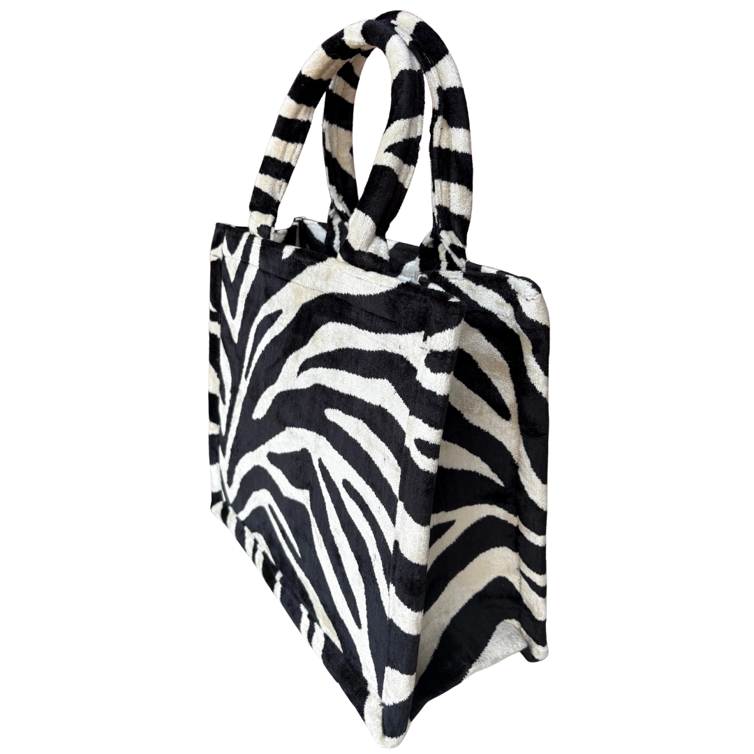 Side view of the Midnight Zebra silk velvet tote showing its boxy base and gusset