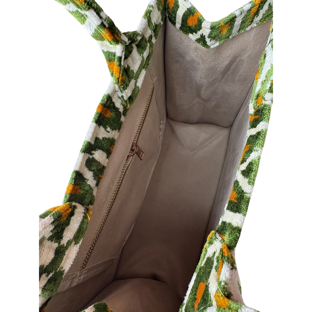 Inside the Olive Ikat Diamond silk velvet tote, showing the taupe lining and zip pocket