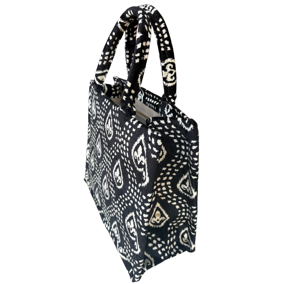 Side view of the Onyx Paisley silk velvet tote showing its boxy base and gusset