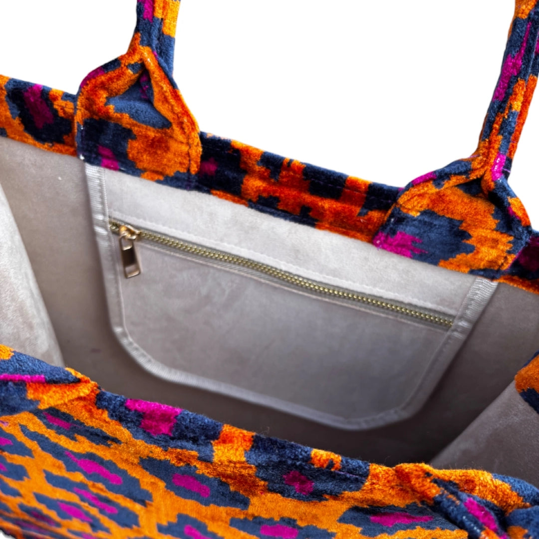 Inside the Orange Leopard silk velvet tote, showing the taupe lining and zip pocket