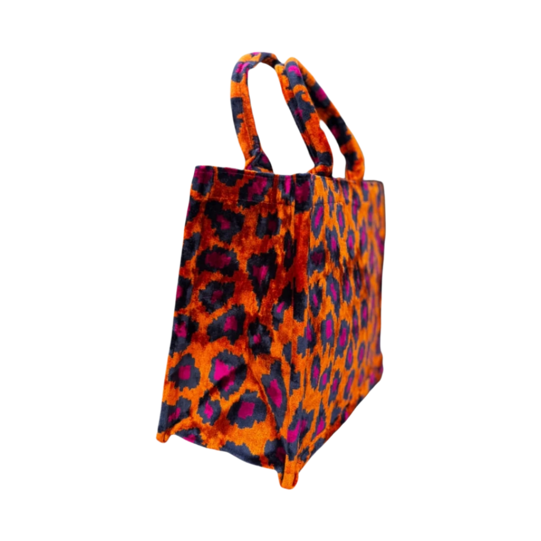 Side view of the Orange Leopard silk velvet tote showing its boxy base and gusset
