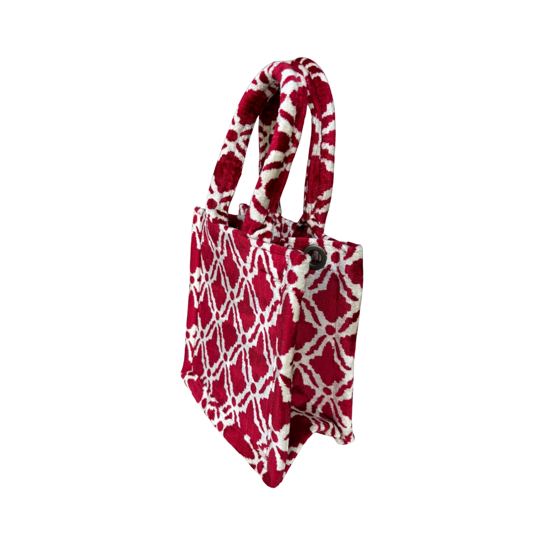 Side view of the Ruby Trellis silk velvet tote showing its boxy base and gusset