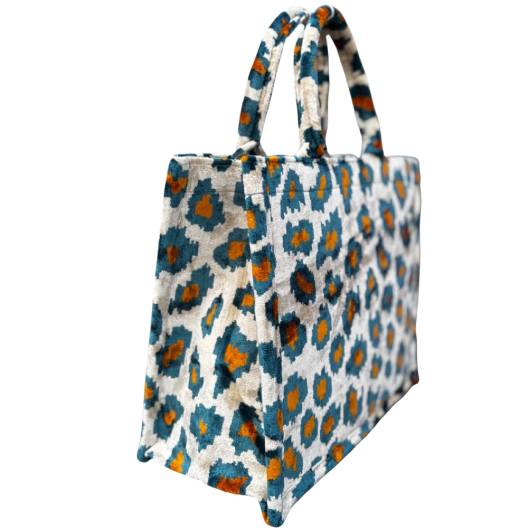 Side view of the Steel Leopard silk velvet tote showing its boxy base and gusset