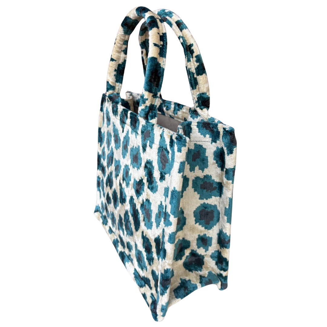 Side view of the Teal Leopard silk velvet tote showing its boxy base and gusset