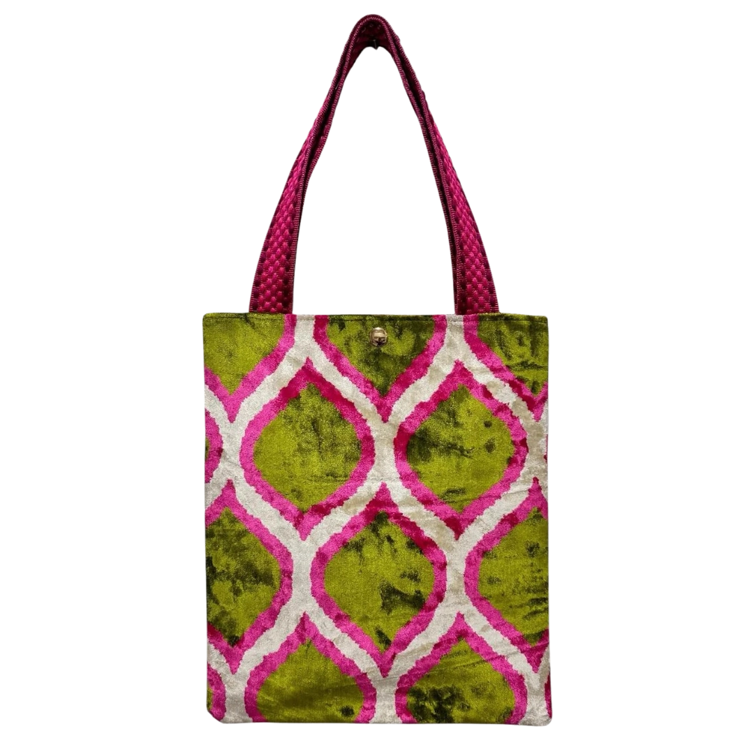 Tote bag with green and pink geometric pattern on a white background