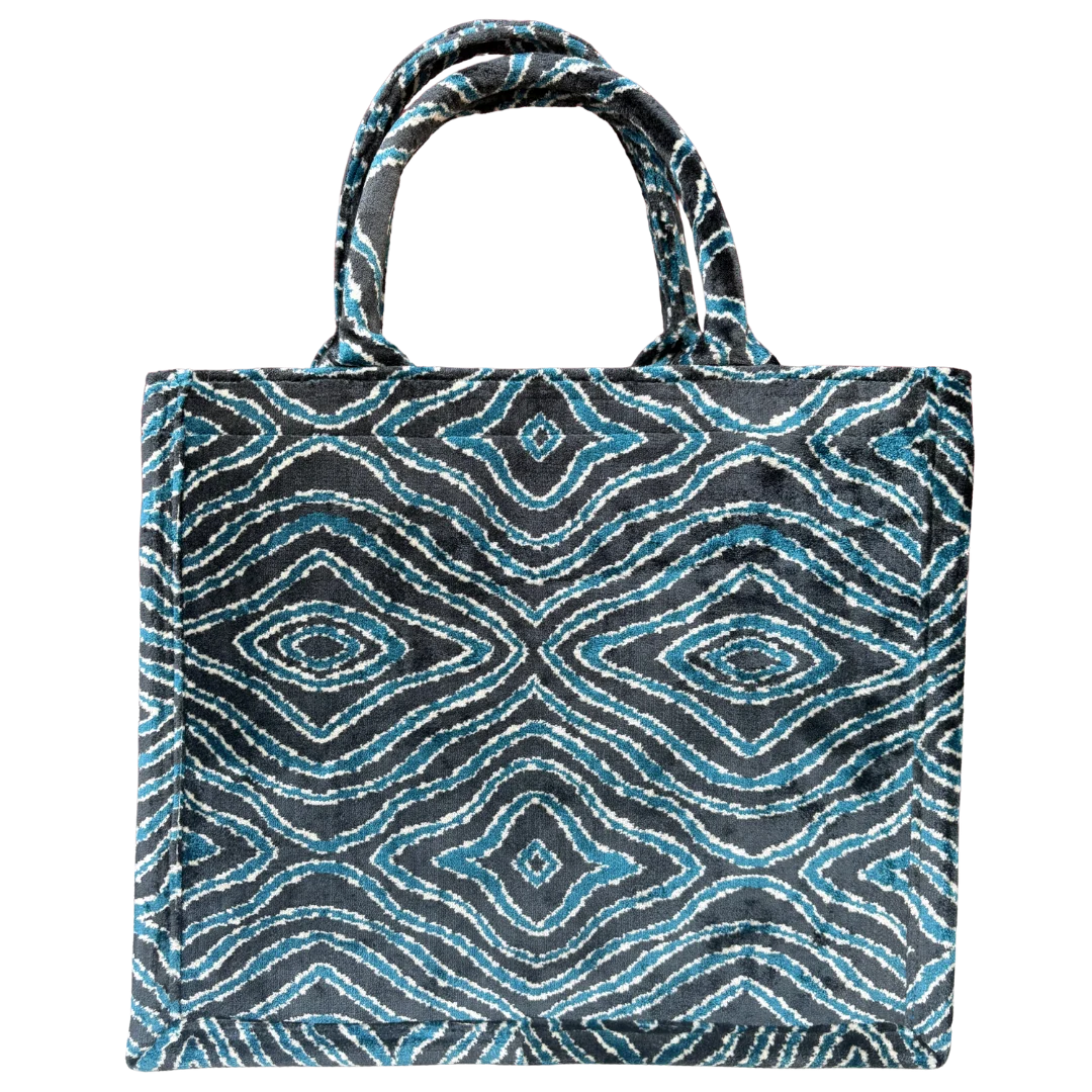 Tote bag with blue and black geometric pattern on a white background