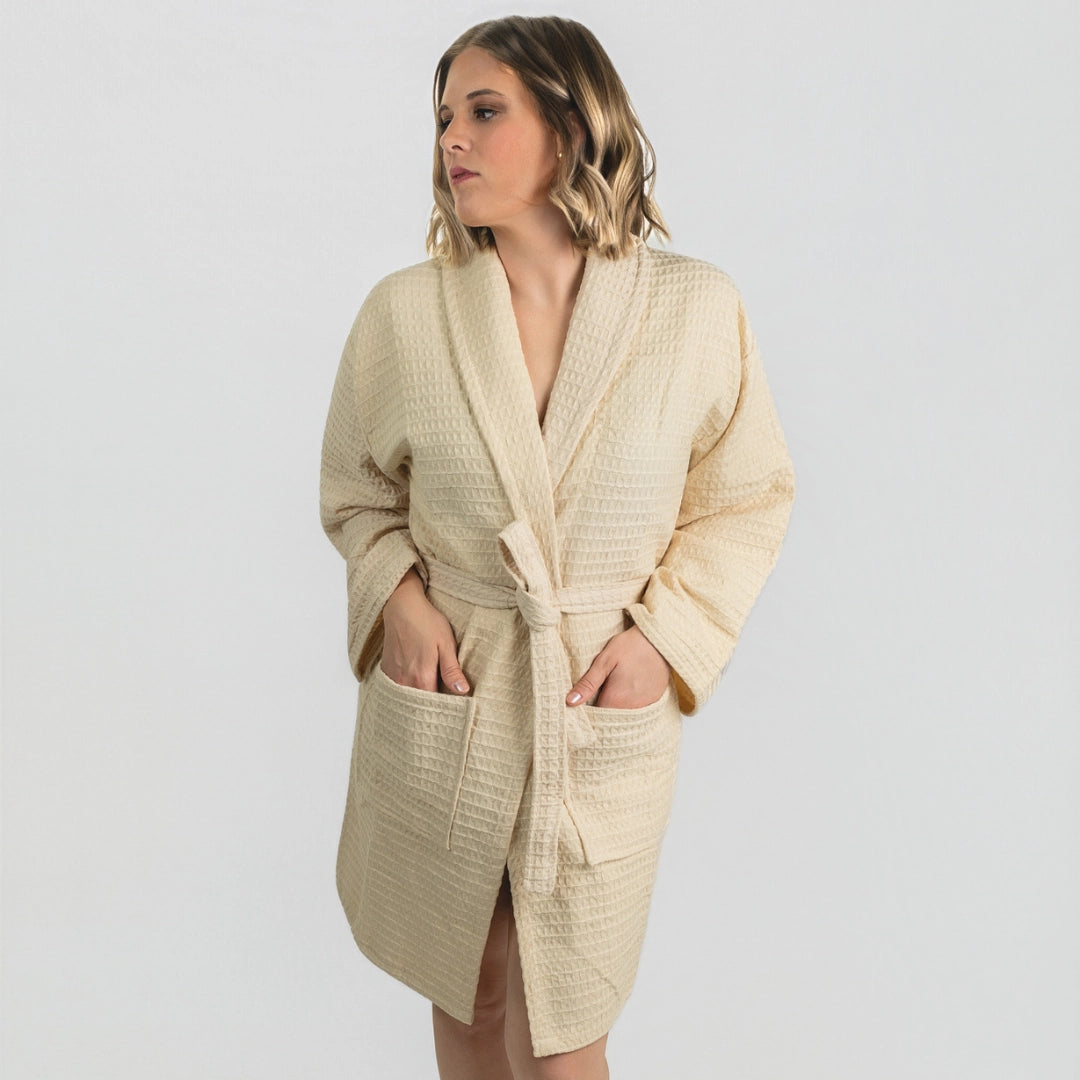 Woman wearing the Aegean Sand Beige waffle weave peshtemal bathrobe, front view