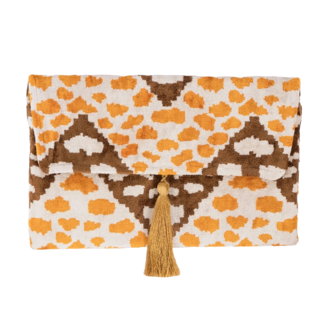 Amber leopard spots and brown ikat diamonds on an ivory silk velvet clutch with tassel