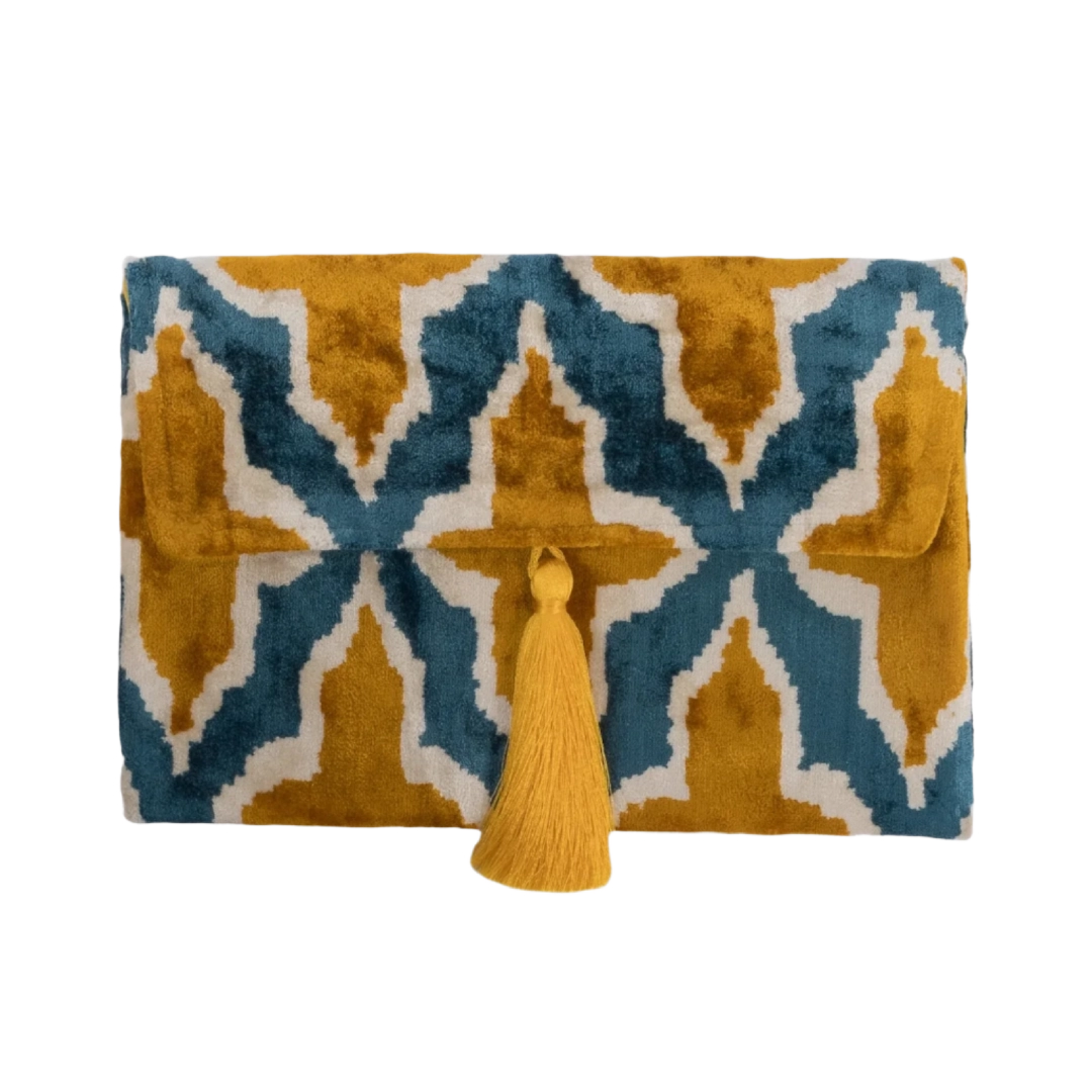 Saffron gold quatrefoil motifs on a teal silk velvet clutch with a gold tassel
