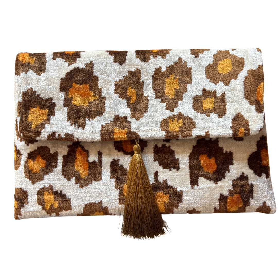 Brown and gold leopard rosettes on an ivory silk velvet clutch with a cinnamon tassel