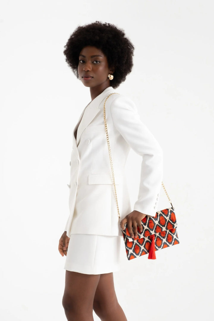 The amber and anthracite diamond silk velvet clutch held at the hip