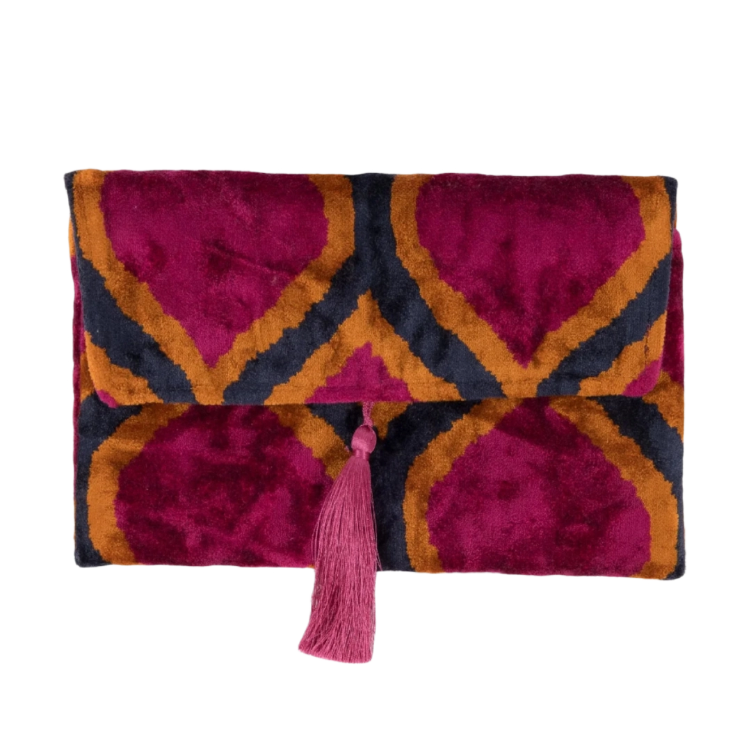 Fuchsia, navy and gold raindrop motifs on a silk velvet clutch with a pink tassel