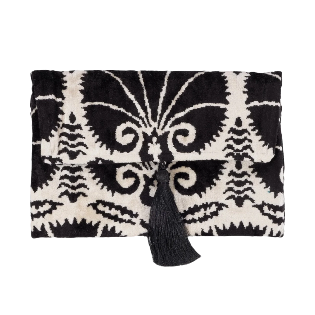 Ivory Fiori blooms on a black silk velvet clutch with a black tassel, front view