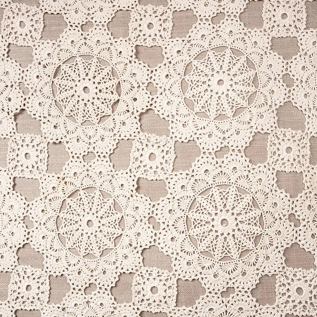 Close-up of the cream crocheted lace medallions on the lacework pillow cover