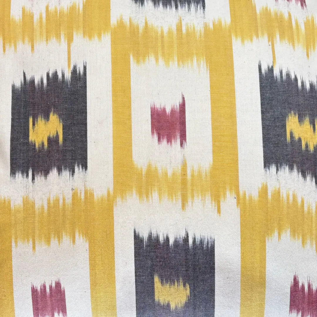 Close-up of the saffron grid ikat weave with charcoal and berry squares