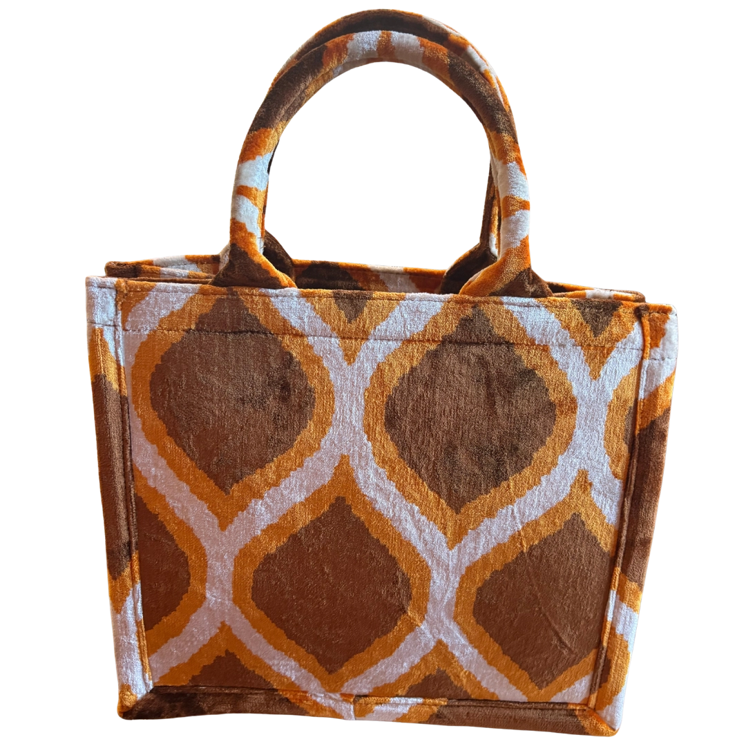 Chocolate brown and amber Drop pattern silk velvet tote bag on an ivory ground, front view