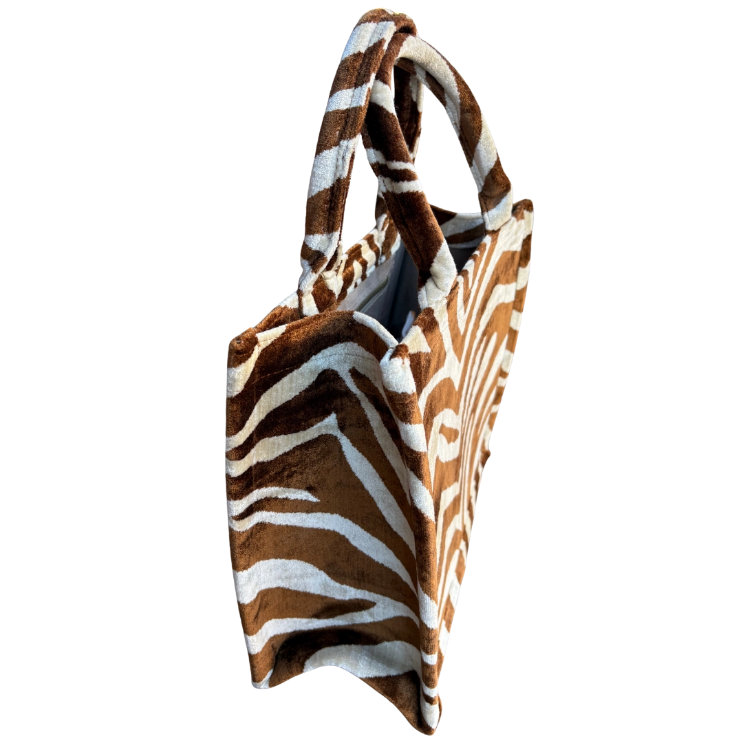 Side view of the Desert Zebra silk velvet tote showing its boxy base and gusset