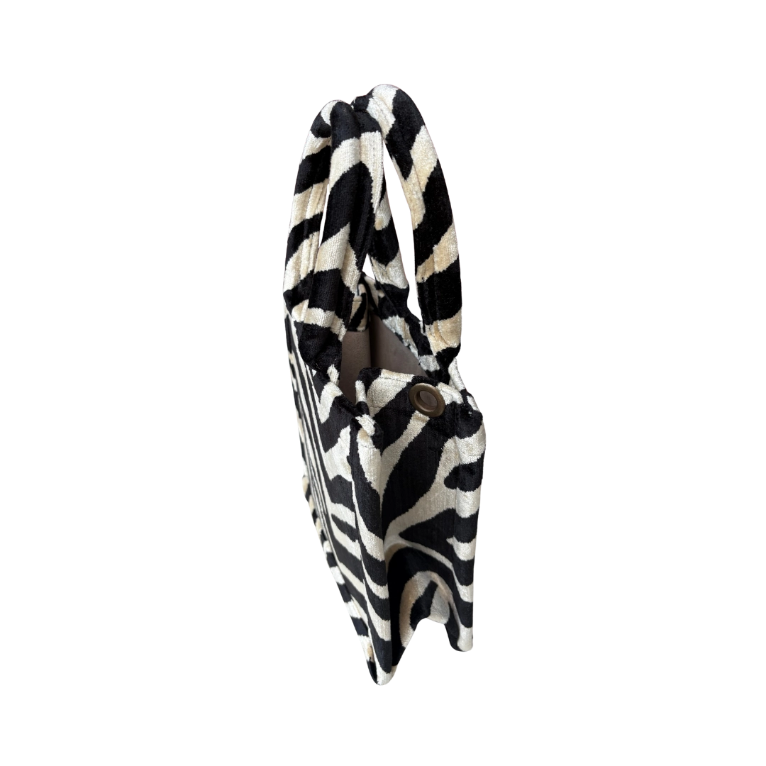 Side view of the Ebony Zebra silk velvet tote showing its boxy base and gusset