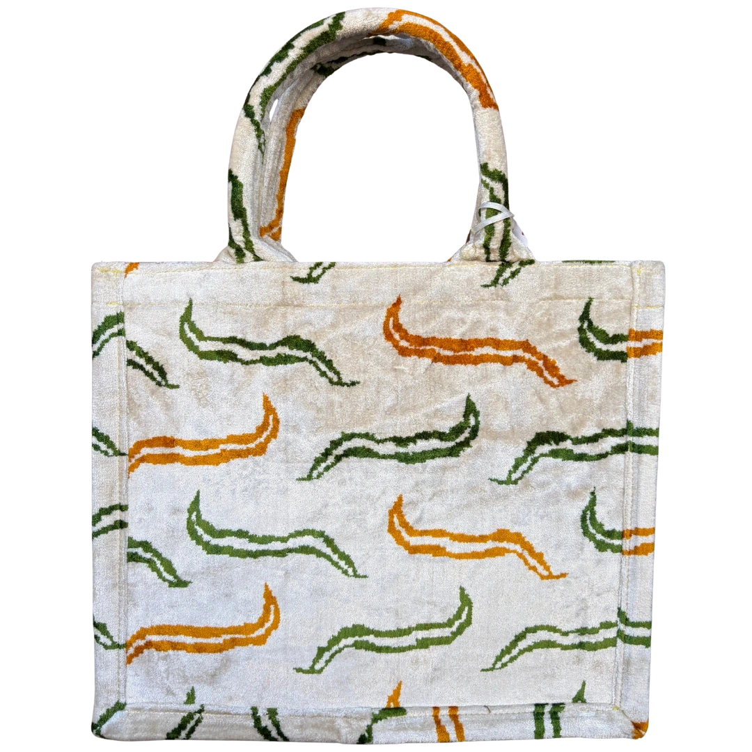 Cream, orange and green meandering vine silk velvet tote bag with matching handles, front view