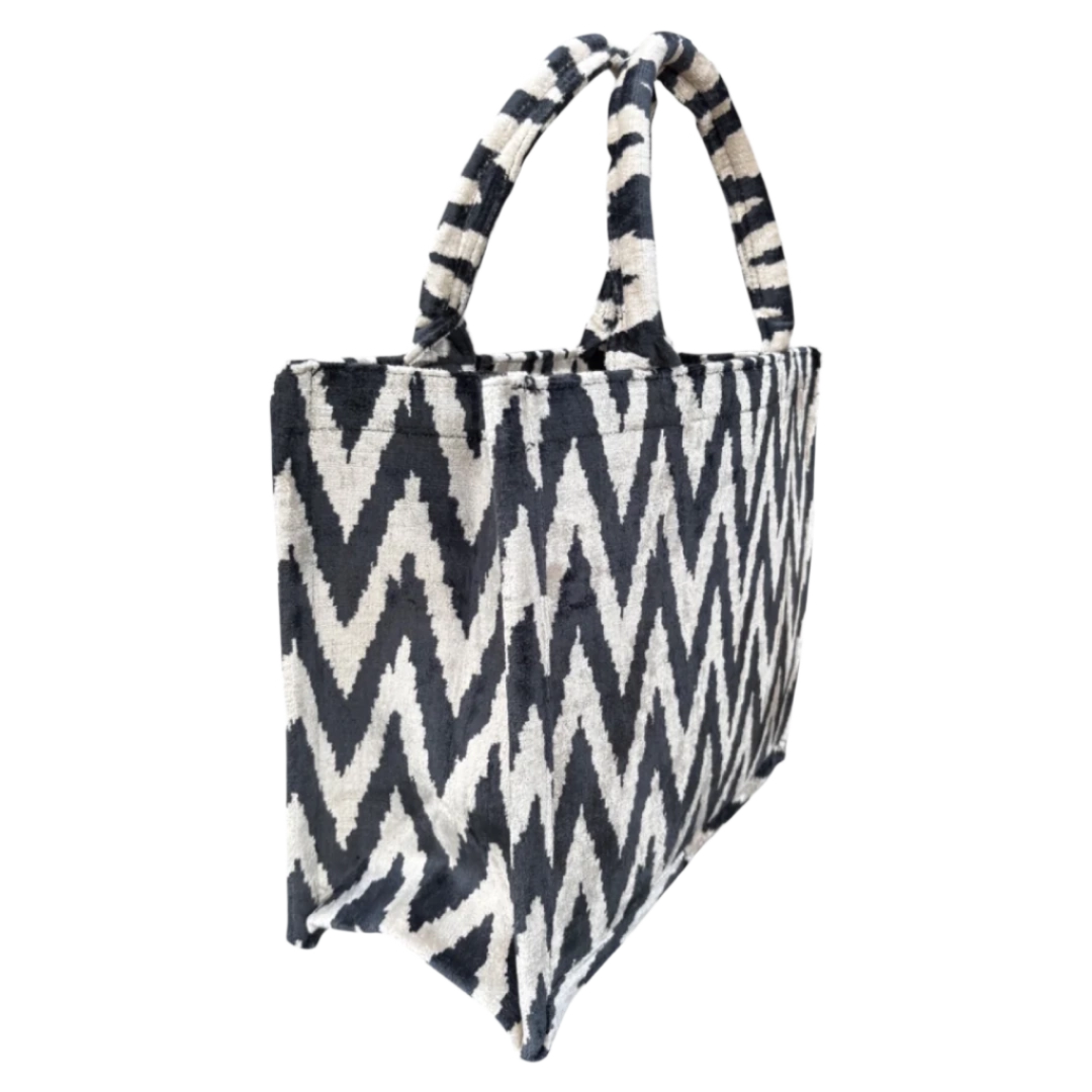 Side view of the Monochrome Chevron silk velvet tote showing its boxy base and gusset