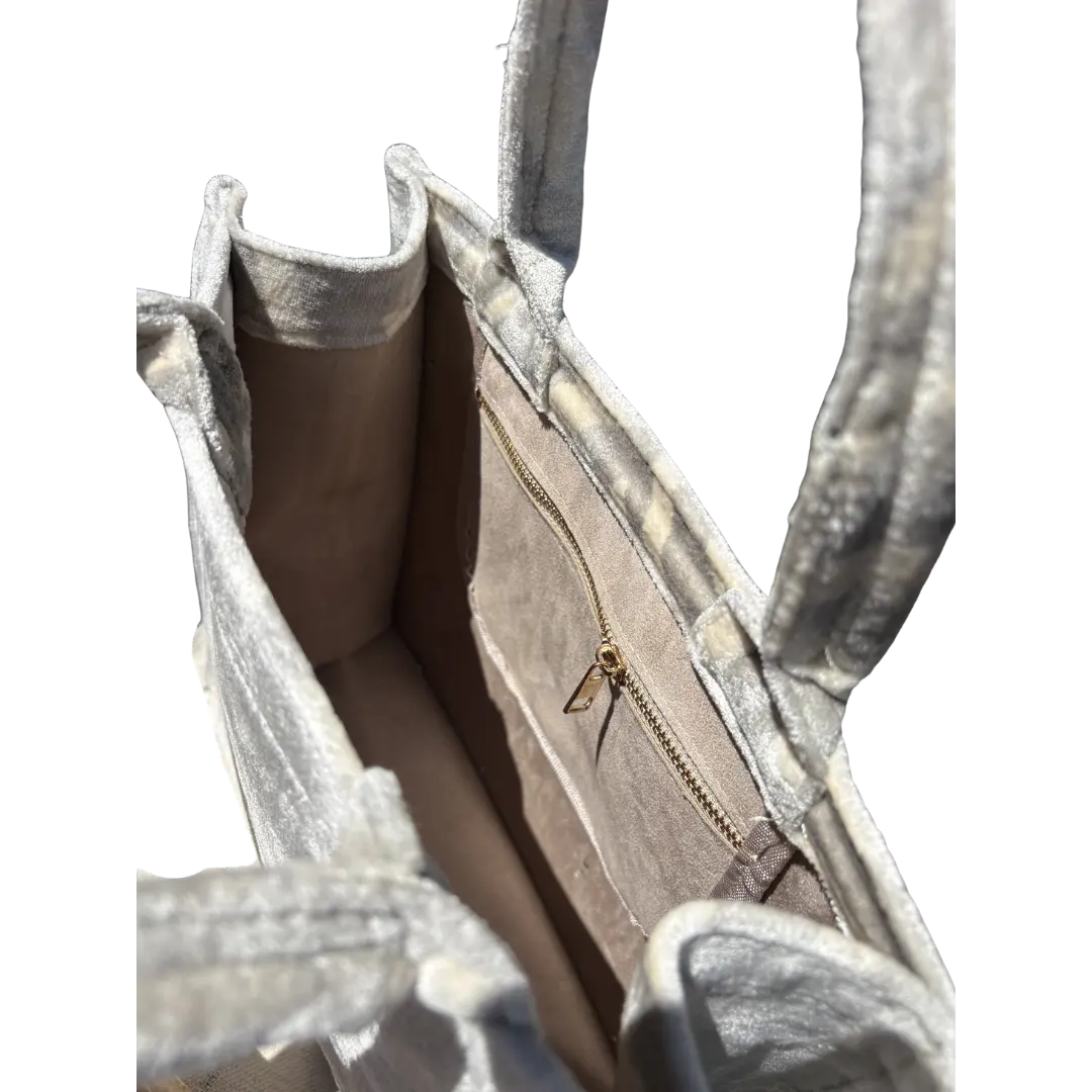 Inside the Moonlight Zebra silk velvet tote, showing the taupe lining and zip pocket