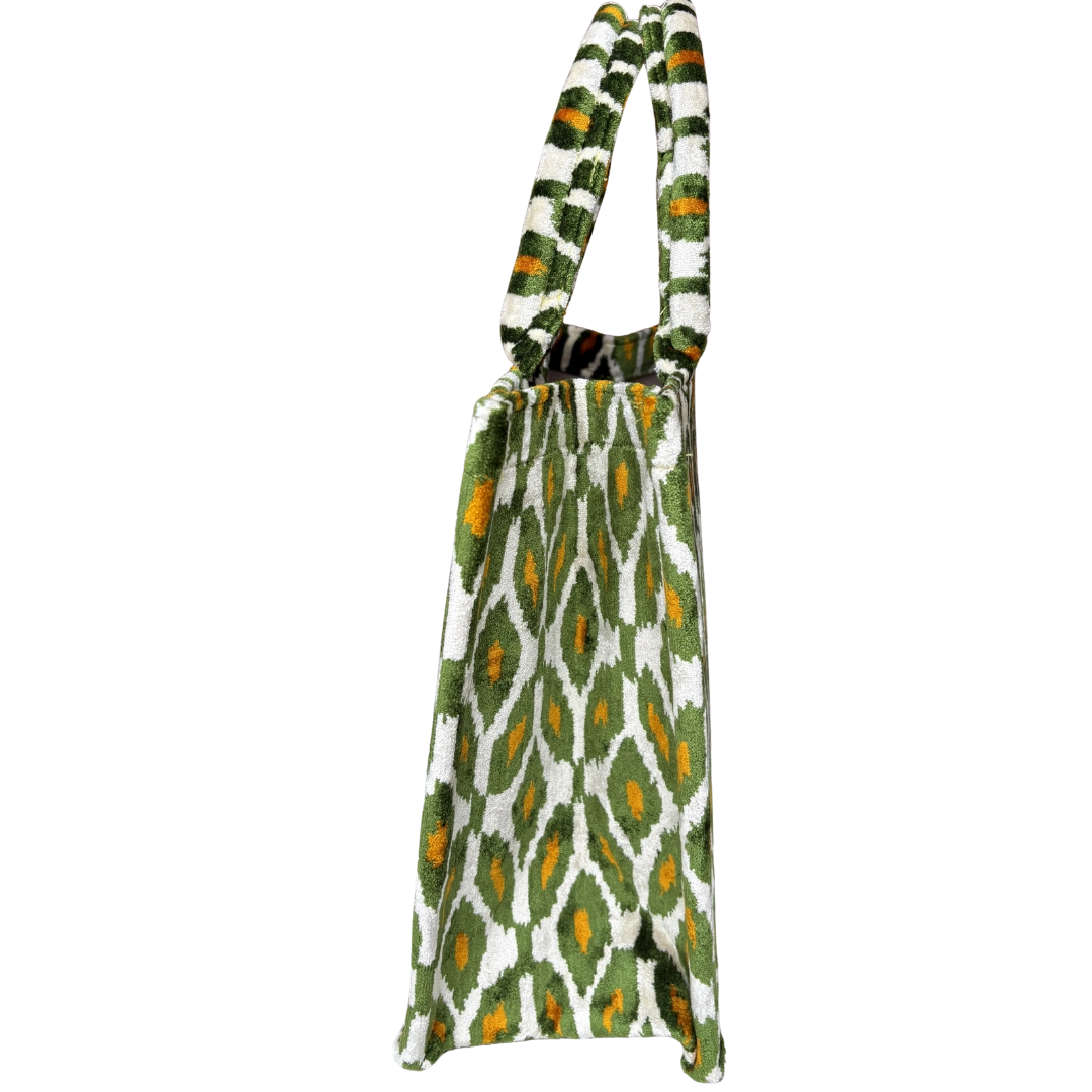 Side view of the Olive Ikat Diamond silk velvet tote showing its boxy base and gusset