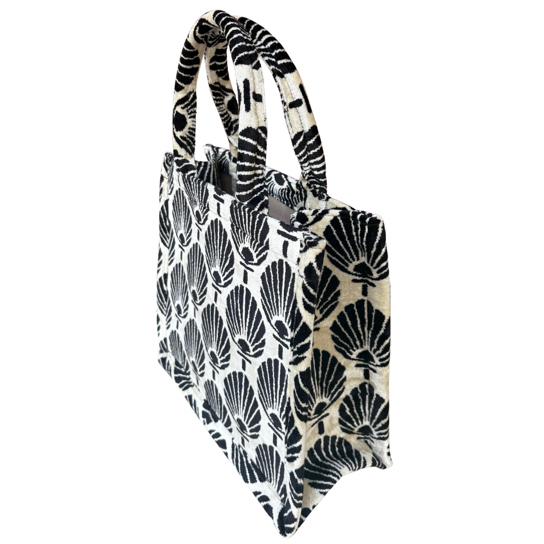 Side view of the Scallop Shell silk velvet tote showing its boxy base and gusset