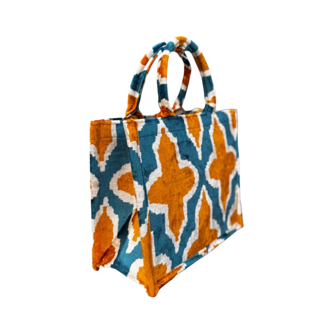 Side view of the Sunset Trellis silk velvet tote showing its boxy base and gusset