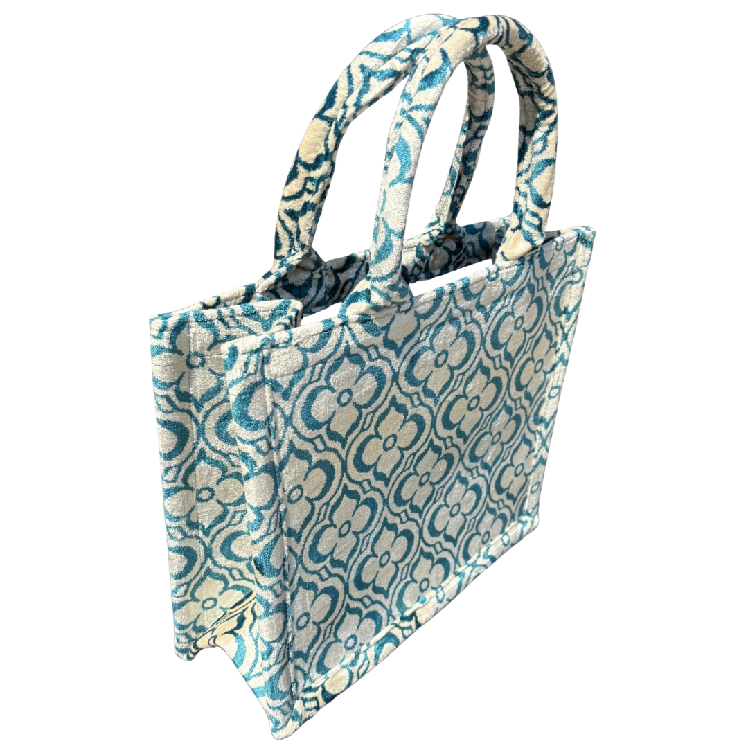 Side view of the Teal Medallion silk velvet tote showing its boxy base and gusset
